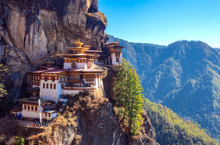 Tiger's Nest Monastery perched on cliff face in Bhutan's Paro Valley with mountains in background